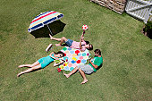 Friends sunbathing and relaxing on sunny grass