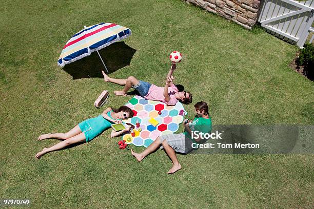 Friends Sunbathing And Relaxing On Sunny Grass Stock Photo - Download Image Now - Yard - Grounds, Picnic, Summer