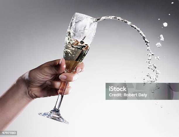 Champagne Spilling From Glass Stock Photo - Download Image Now - Spilling, Drinking, Alcohol - Drink