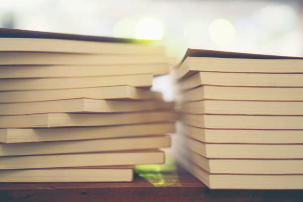 istock Book stack in the library room and blurred bookshelf for business and education background, back to school concept 979712004
