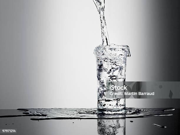 Water Pouring Into Glass And Overflowing Stock Photo - Download Image Now - Water, Drinking Glass, Overflowing