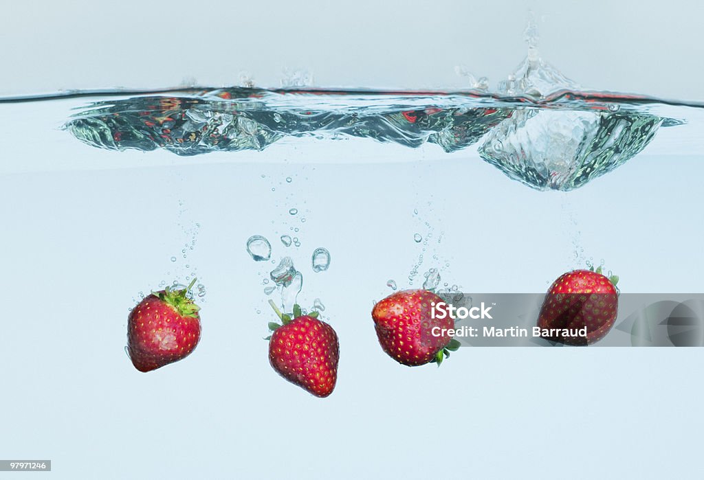 Strawberries splashing in water  Water Stock Photo