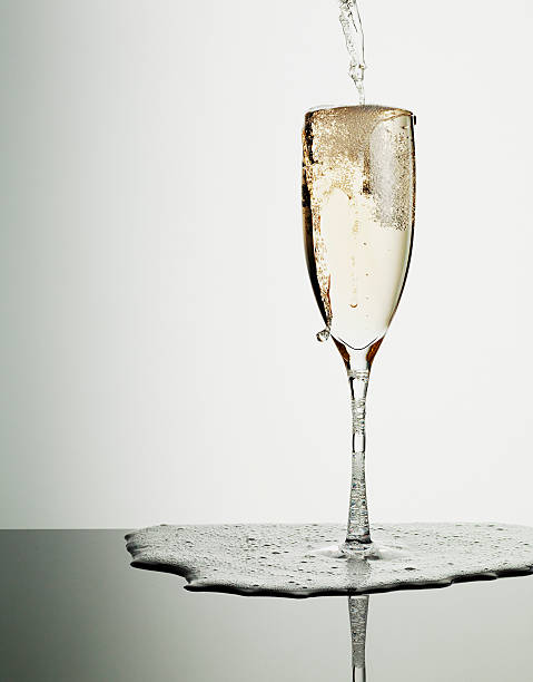 champagne verser dans le verre et débordant - champagne champagne flute pouring wine photos et images de collection