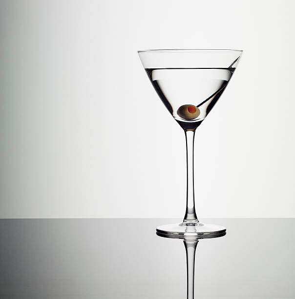 Martini in glass with green olive  martini glass photos stock pictures, royalty-free photos & images
