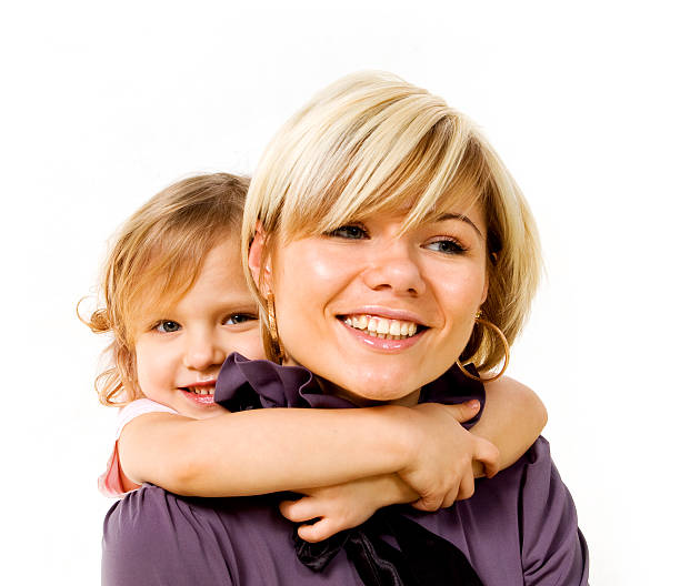 little girl hugging a mother stock photo