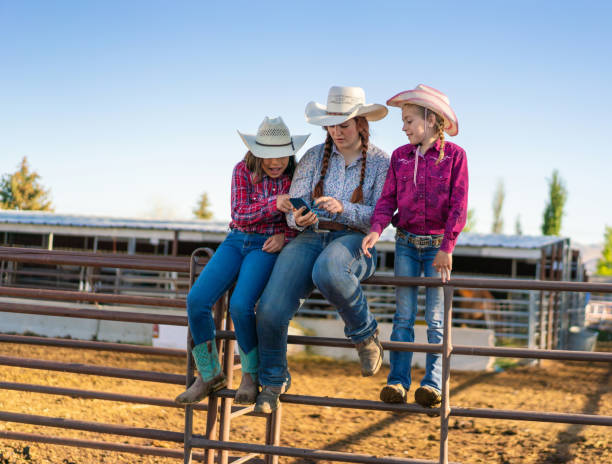 istock Cowgirls using a smart phone at a ranch 979743940
