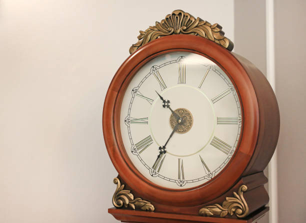 istock Ancient style standing pendulum clock in the house. 979748194