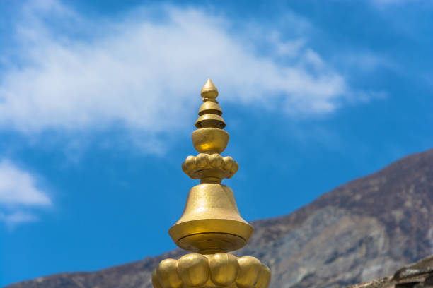 Bronze tip of stone stupa on blue sky background, Nepal.