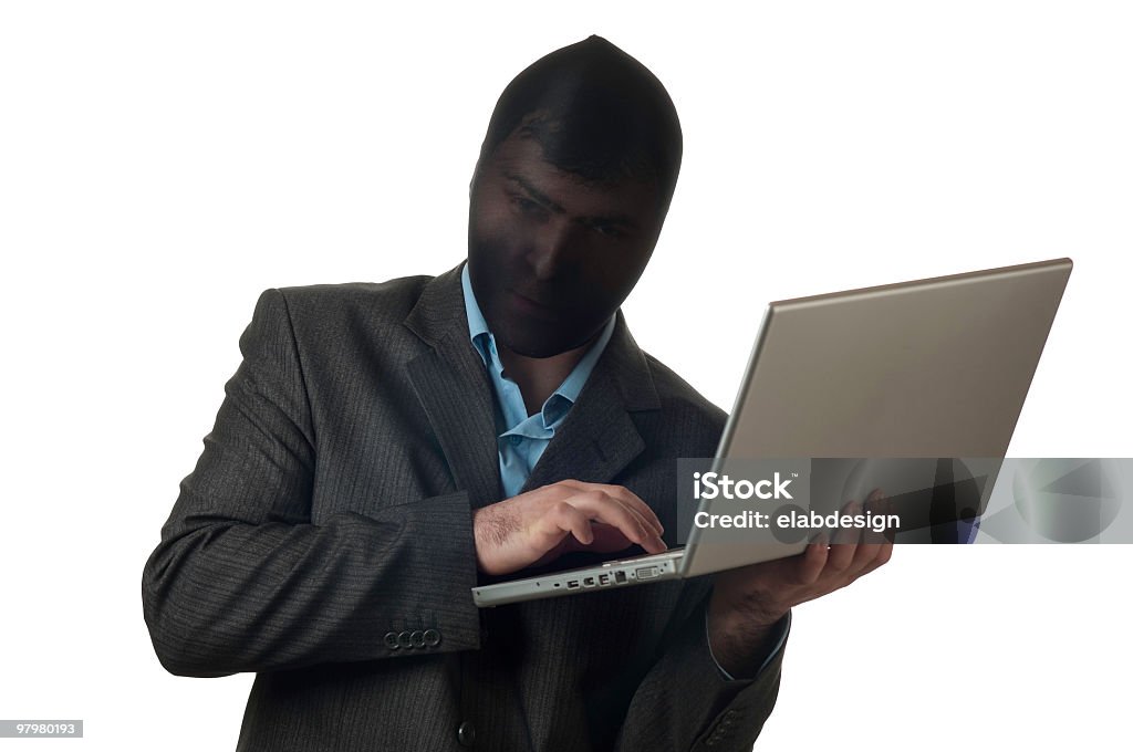 Masked man making the Internet a crime  Adult Stock Photo