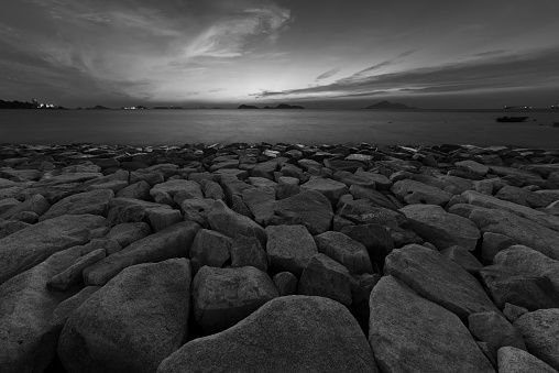 rock beach at dusk in black and white