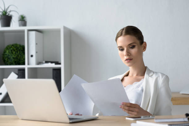 istock focused young businesswoman doing paperwork at office 979872536