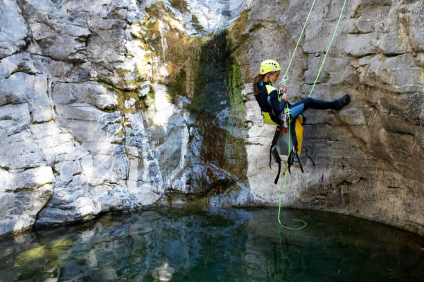 Woman canyoneering in Pyrenees Canyoning in Lapazosa Canyon, Bujaruelo Valley, Pyrenees, Huesca Province, Aragon, Spain. canyoneering stock pictures, royalty-free photos & images