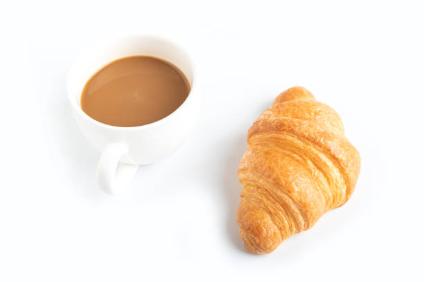 istock Coffee and croissant on white background 979878354