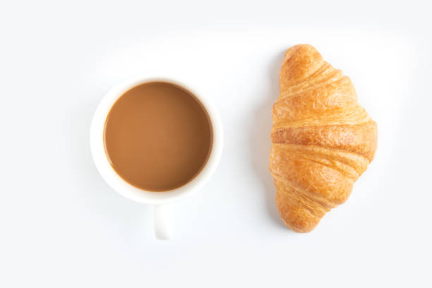 istock Coffee and croissant on white background 979878364