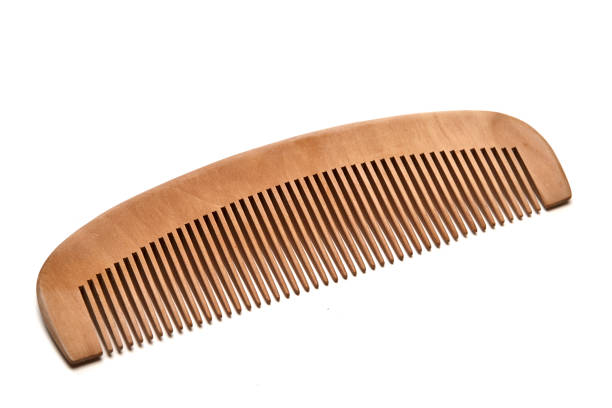 closeup brown wooden comb on a white background