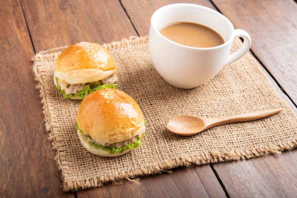 istock tuna burger and coffee on wood background. 979885452