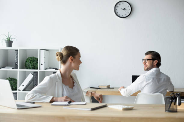 istock young business colleagues chatting at workplace in office 979890976