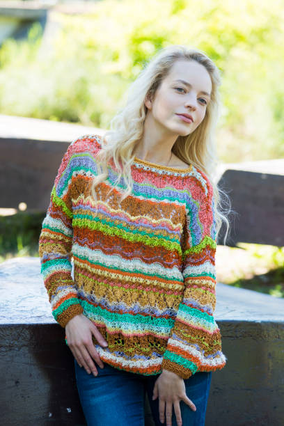 istock The thoughtful girl poses outdoors in a knitted pullover 979892220