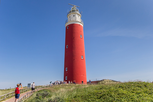 Texel, Netherlands - June 07, 2018: Tourist group visiting the lighthouse on Texel island, Holland