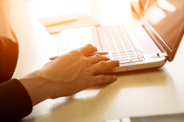istock Business man hand on notebook keyboard 979905772