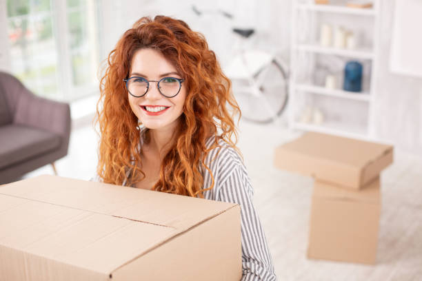 istock Merry beautiful woman getting ready for moving out 979907074