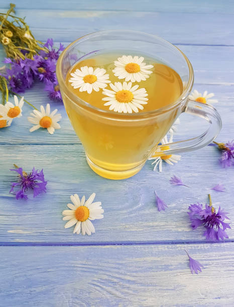 istock chamomile tea, cornflower on a wooden background 979907250