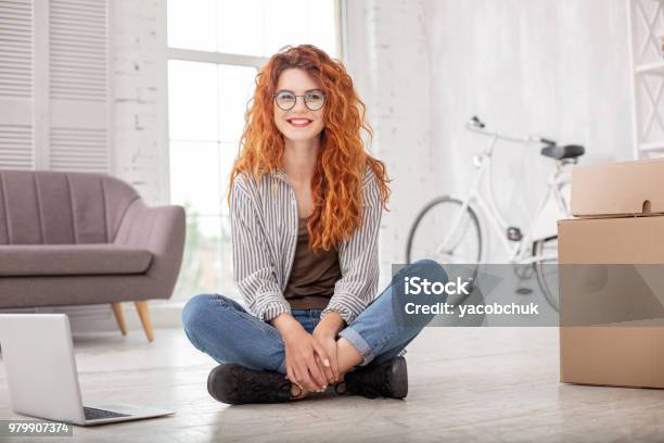 Positive Pleased Woman Packing Belongings Stock Photo - Download Image Now - Millennial Generation, Apartment, Facial Expression