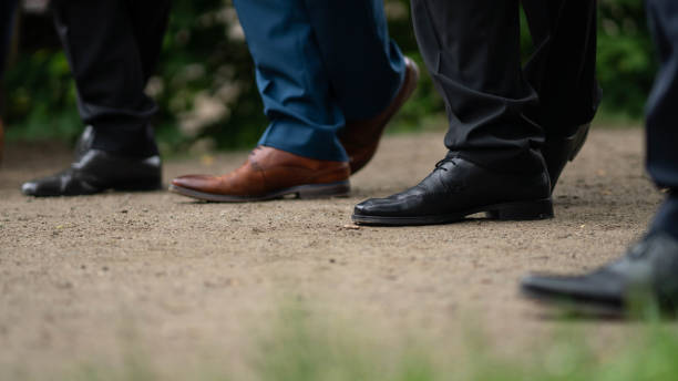 istock four men in shoes. stand in an interesting pose 979907392