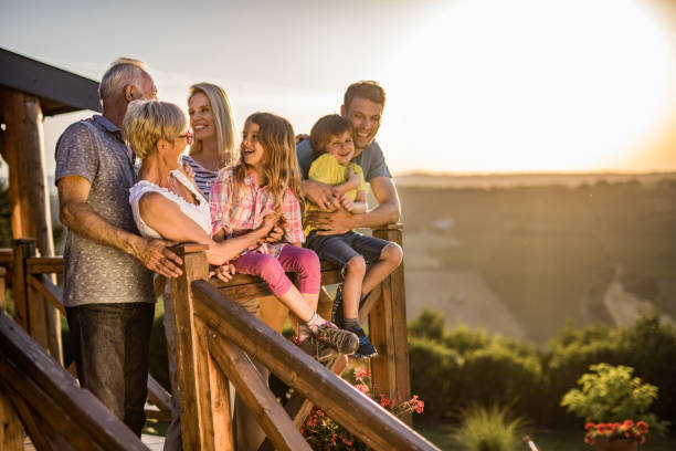 istock Happy extended family having fun while talking on a terrace. 979907428
