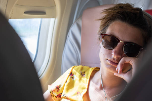 istock Young Woman Sleeping on Airplane 979916330