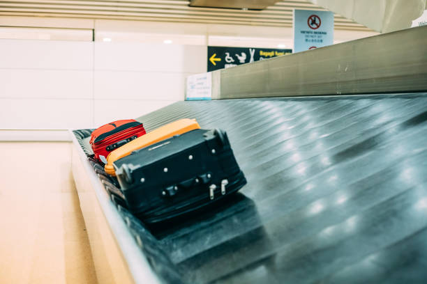istock Suitcases on Baggage Claim Conveyor Belt ait Airport 979916396