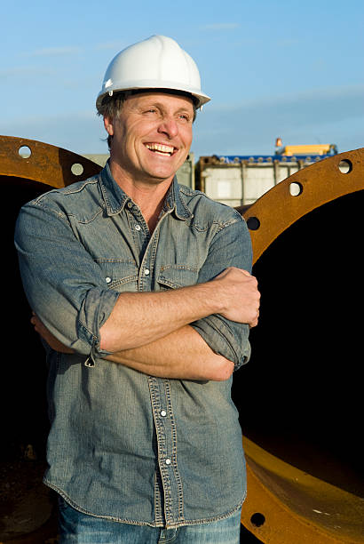 Male construction worker on job site smiling stock photo