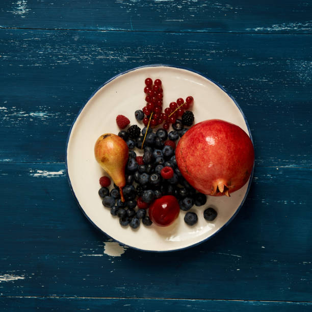 Fruits and berries lying on round plate