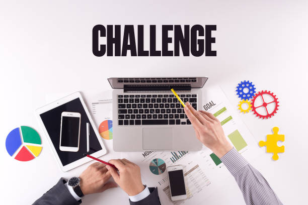 istock Business team working on desk with a single word CHALLENGE 979935838