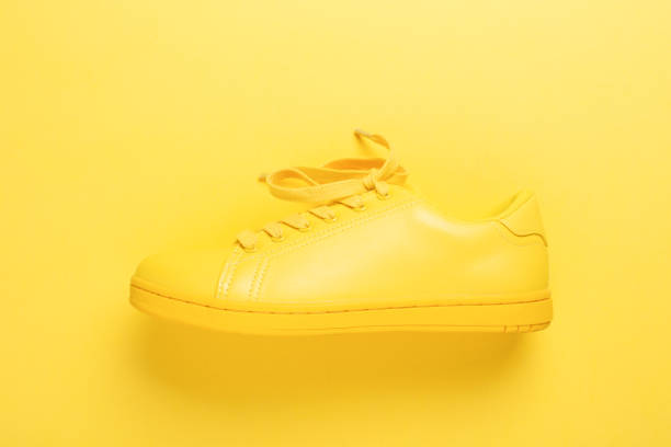 istock One yellow shoe on yellow background. 979936170