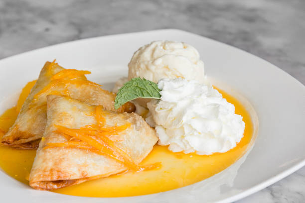 istock Crepes Suzette: French thin pancake with orange sauce and ice cream 979937156