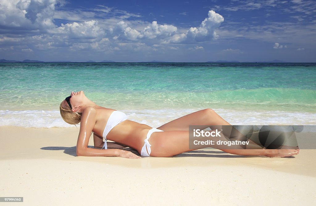 Young attractive woman relaxing on the beach.  Adult Stock Photo