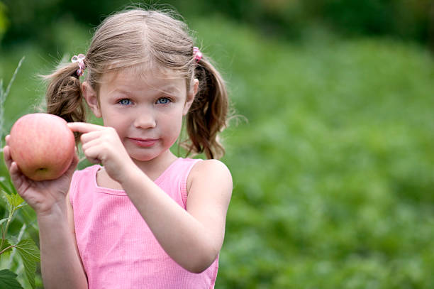 Pretty Little girl with a Apple stock photo