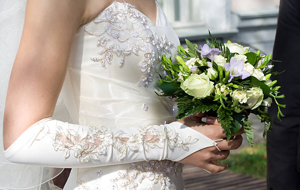 istock bride's hand holding bunch of flowers 97994403