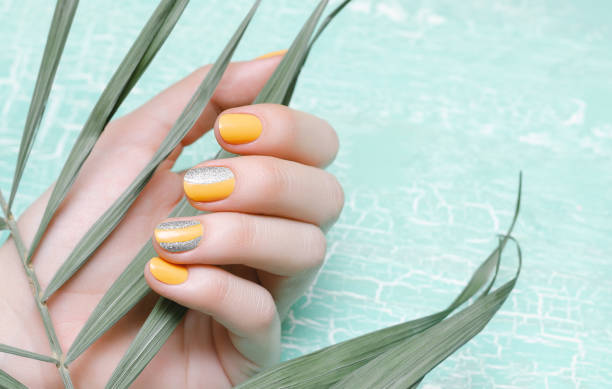istock Female hands with orange nail design 979944638
