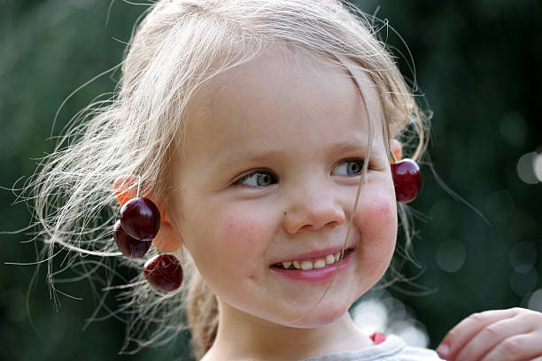 Girl with cherries stock photo