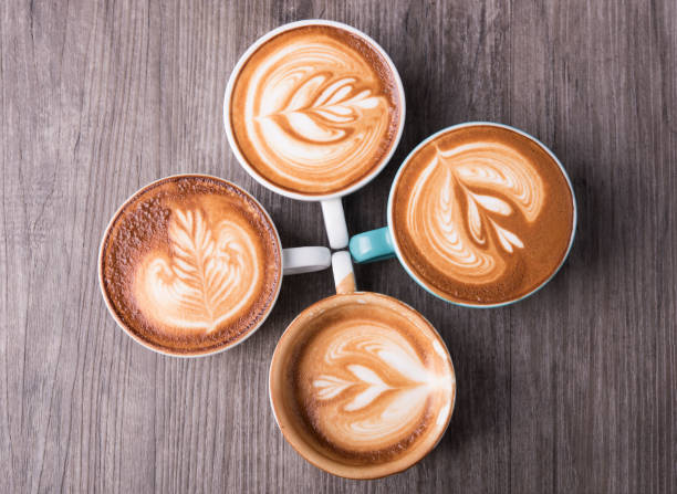 istock latte or Cappuccino with frothy foam, coffee cup top view on table in cafe. 979955044