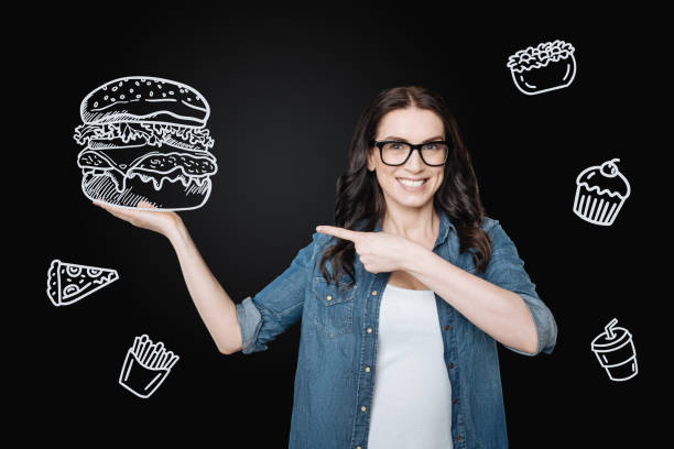 istock Hungry woman feeling excited while ordering a giant hamburger 979957120