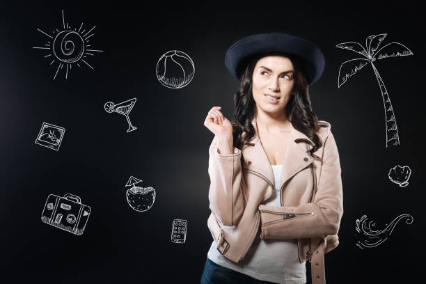 istock Curious woman wearing a hat and looking to the right while thinking 979962664