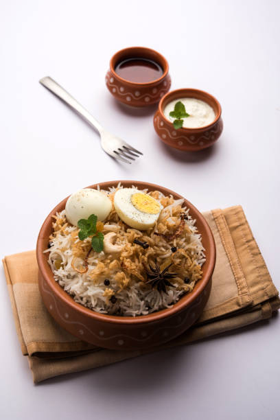 istock Egg Biryani - Basmati rice cooked with masala roasted eggs and spices and served with yogurt, selective focus 979963882