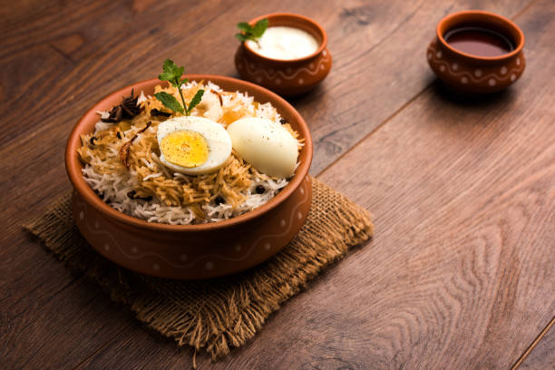 istock Egg Biryani - Basmati rice cooked with masala roasted eggs and spices and served with yogurt, selective focus 979966930
