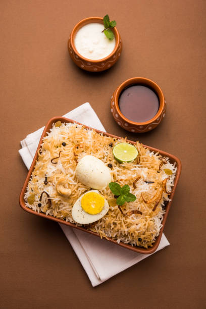 istock Egg Biryani - Basmati rice cooked with masala roasted eggs and spices and served with yogurt, selective focus 979967902