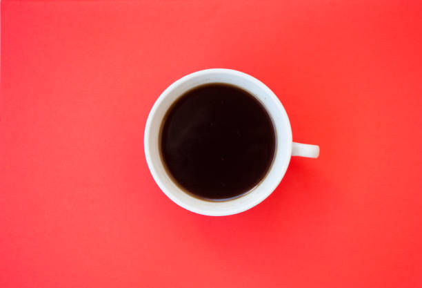istock A cup of coffee on red background. 979968526