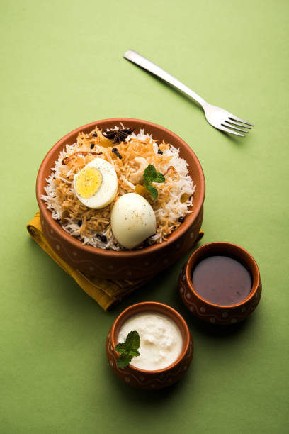 istock Egg Biryani - Basmati rice cooked with masala roasted eggs and spices and served with yogurt, selective focus 979971212