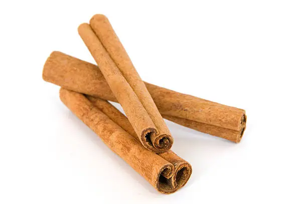 Photo of Cinnamon sticks on white